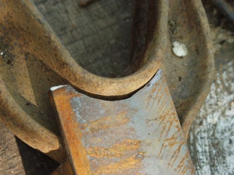 1979 Ford Bronco - This close-up shows a rusty metal component with a cut edge, likely a vehicle part.