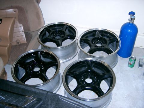 1996 Ford Probe - Four aftermarket rims are displayed alongside a blue nitrous oxide tank and a can of soda.