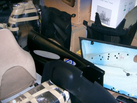 1996 Ford Probe - Various car interior components are piled together, some wrapped in insulation and tape.