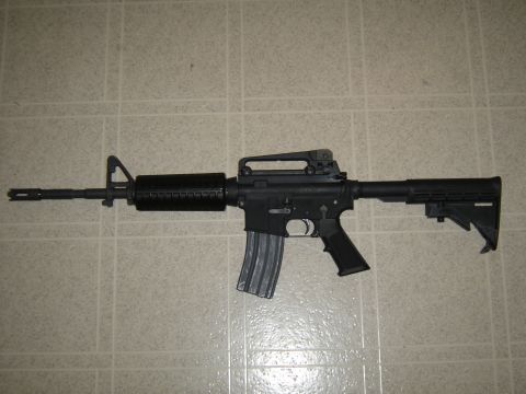 1988 Ford Bronco - An AR-15 style rifle is shown against a tiled background.