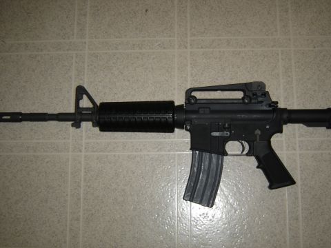 1988 Ford Bronco - A black AR-15 style rifle is shown against a tiled background.