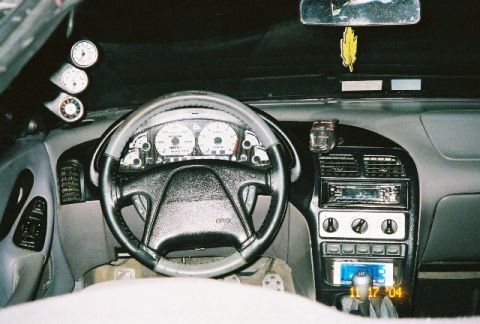 1995 Ford Probe - The dashboard features aftermarket gauges and a modified stereo system.