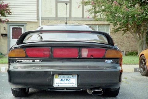 1995 Ford Probe - Rear view of a black 1995 Ford Probe, identifiable by its taillight design and 'Probe 16V' badging.