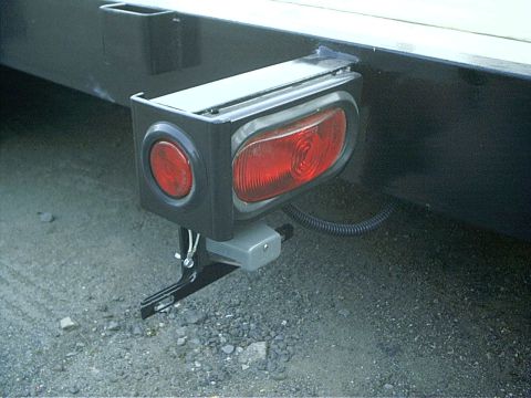 1979 Ford Bronco - Close-up of a trailer's rear lighting system, both circular and oval red lamps.