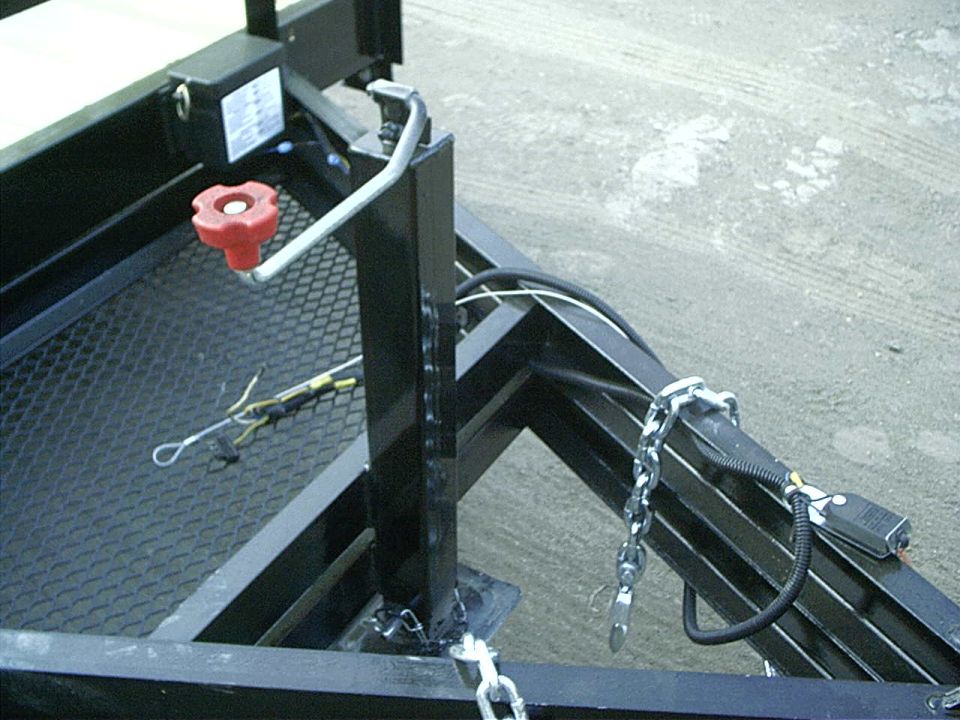 Trailer tongue with a red winch handle, safety chains, and a wiring harness