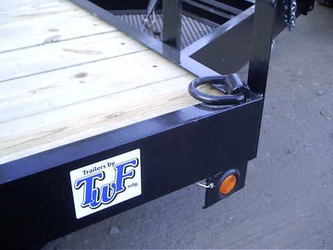 1979 Ford Bronco - Close-up of a trailer deck and frame, showing the TWF Mfg. logo and a D-ring tie-down point.