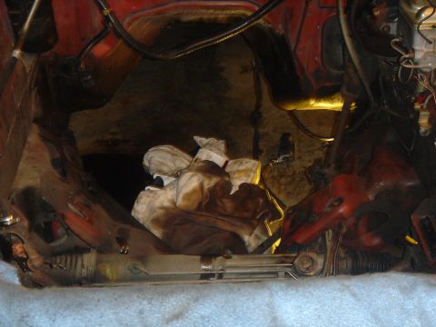 1986 Ford Mustang - Engine bay area with rags covering parts, some red painted components are visible.