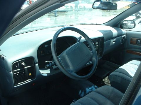 1999 Ford Crown Victoria - Interior view of a car's dashboard, steering wheel, and seats, with a watermark at the bottom.