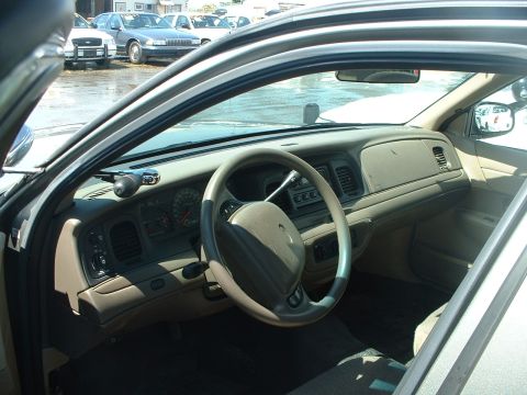1999 Ford Crown Victoria - Interior view of a 1999 Ford Crown Victoria, with other vehicles seen through the windows.