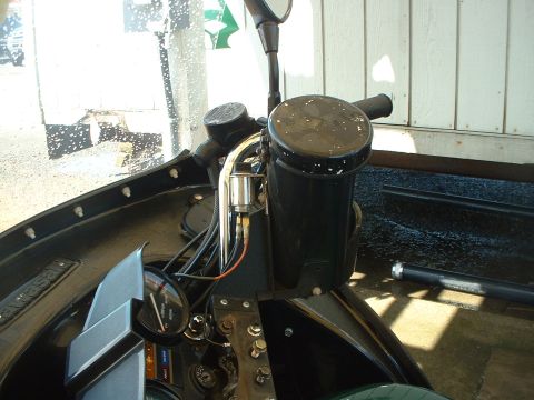1999 Ford Crown Victoria - Close-up view of a motorcycle's interior controls and handlebars, showing a gauge and a black reservoir.