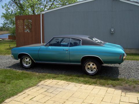 1971 Chevrolet Chevelle - This 1971 Chevrolet Chevelle coupe features a teal exterior with a contrasting black vinyl roof and classic rally wheels.