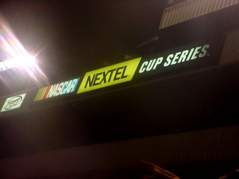 1973 Ford Ranchero - A sign displays 'NASCAR NEXTEL CUP SERIES' in a dimly lit indoor venue.