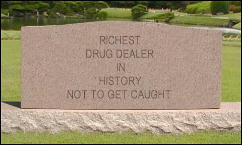 1986 Ford Bronco - A gravestone inscribed with a humorous epitaph stands in a manicured garden.