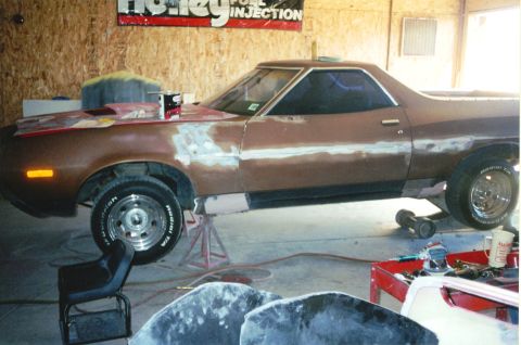 1972 Ford Ranchero - This pickup truck is in a garage, being worked on with body filler visible on its side.