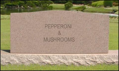 1995 Ford Bronco - Gravestone engraved with 'PEPPERONI & MUSHROOMS' stands in a landscaped park.