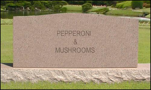 Gravestone engraved with 'PEPPERONI & MUSHROOMS' in a park setting