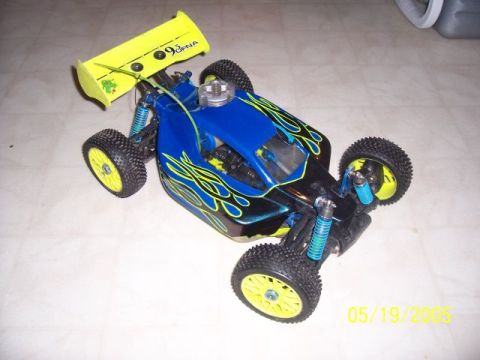1987 Ford Bronco - A blue and black remote control buggy with yellow accents is shown from a high angle.