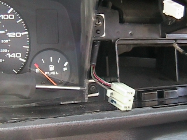 1989 Mazda MX-6 interior dashboard with fuel gauge and exposed wiring