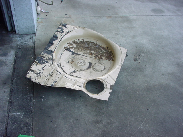 Spare tire well liner with circular indentations and a speaker cutout