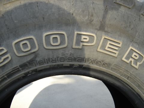 1988 Ford Bronco - Close-up of a Cooper tire, size 33x12.50R15LT.
