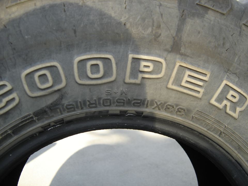 Cooper tire sidewall close-up showing 33x12.50R15LT M+S size marking