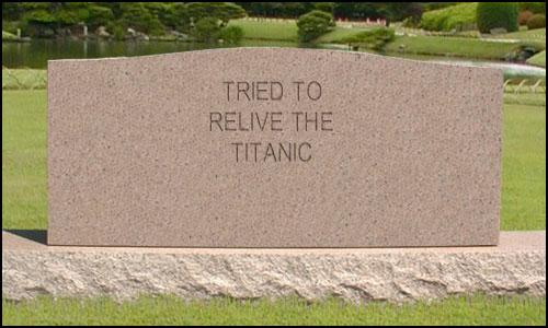 Stone monument with inscription 'TRIED TO RELIVE THE TITANIC' in a park setting