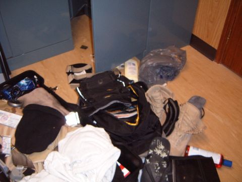 1988 Ford Bronco - A disorganized collection of personal items is scattered across the floor, obscuring the view of the surrounding room.