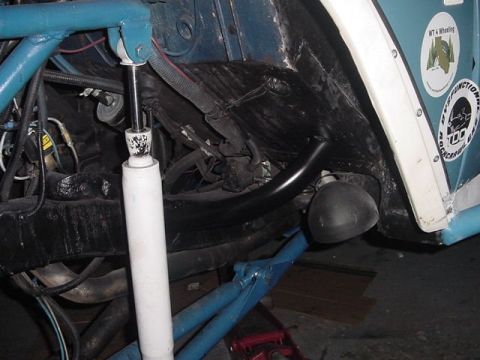 1971 Ford Bronco - Detail shot of the suspension system and inner fender of a vehicle, showing modifications and stickers.