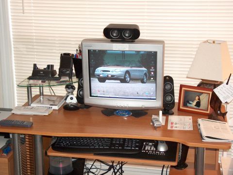 1998 Ford Taurus - A computer monitor displays a silver car, surrounded by typical desk accessories and office supplies.