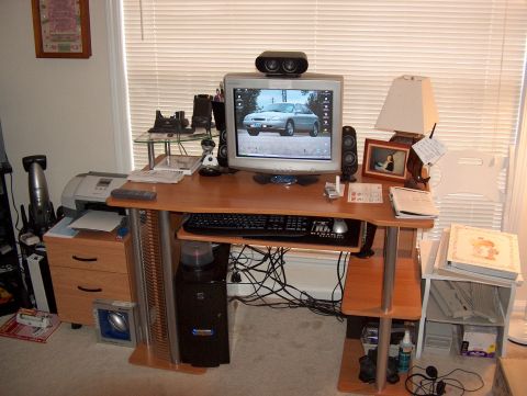 1998 Ford Taurus - A silver sedan is shown on a computer monitor, part of a desk setup.