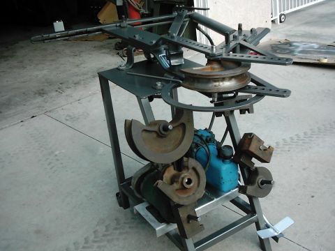 1978 Ford Bronco - A metal bending machine is shown with multiple dies and a blue reservoir, likely used for industrial fabrication.