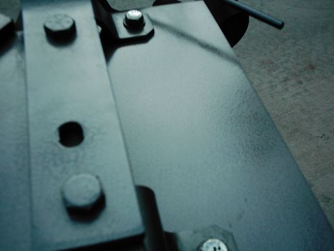 1978 Ford Bronco - This image shows a close-up of metal brackets and bolts, with a watermark for SUPERMOTORS.net.