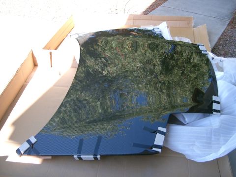 1996 Ford Probe - A carbon fiber car hood is shown unpacked from its shipping box.