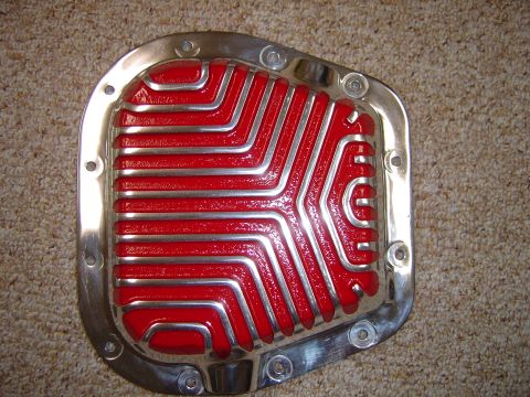 1978 Ford Bronco - This aftermarket differential cover features a bright red and polished chrome finish with a distinctive finned pattern.