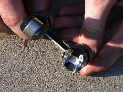 1979 Ford Bronco - Close-up of engine valve lifters being held, showing mechanical parts.