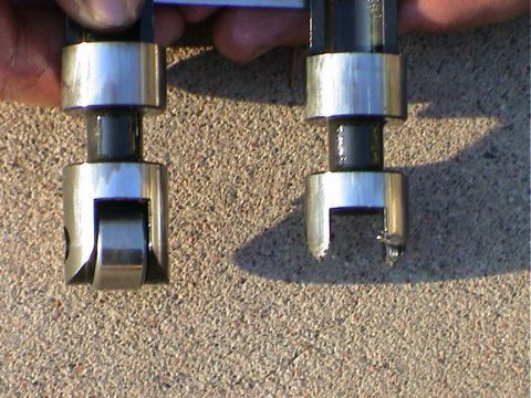 1979 Ford Bronco - Comparison of a new roller lifter and a worn lifter, likely from an engine build.