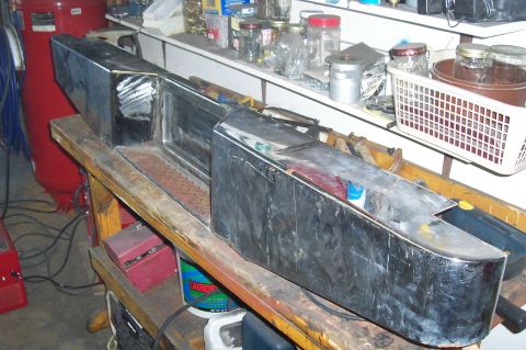 1994 Ford F-150 - A custom-fabricated metal bumper, likely for a truck, is shown on a workbench. It features a large, rectangular recessed area.