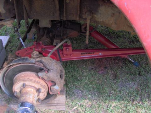 1979 Ford Bronco - Close-up of a red suspension component with visible text, part of a vehicle's undercarriage.