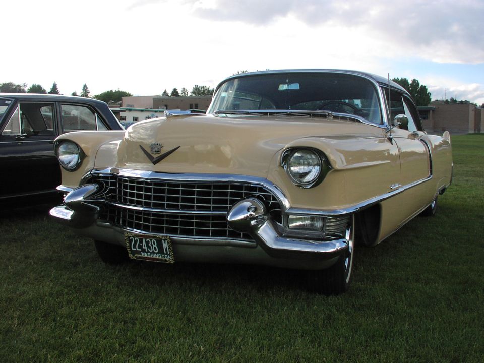 Front view of a tan 1955 Cadillac with a large chrome grille and Washington license plate