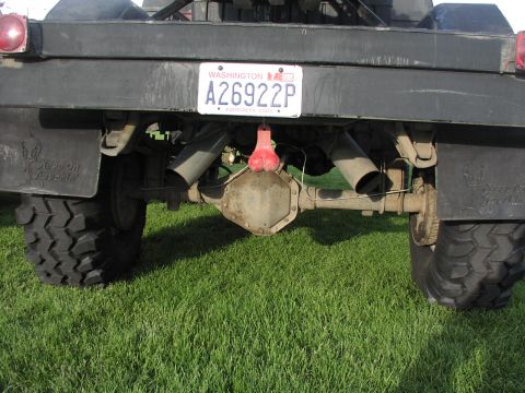 1979 Ford Bronco - This vehicle's rear end is visible, showing off its large tires, dual exhaust, and a Washington license plate.