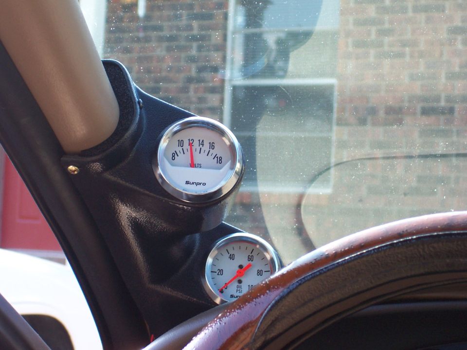 Interior view of Sunpro volt and PSI gauges mounted on a dash pod