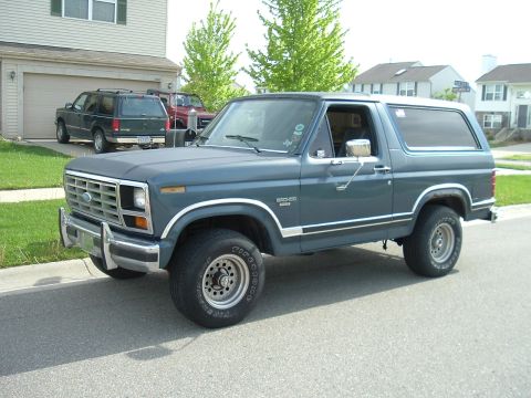 1982 Ford Bronco - This 1982 Ford Bronco is parked in front of a suburban house with other vehicles in the driveway.