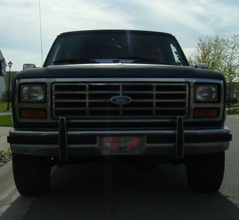 1982 Ford Bronco - Front view of a black Ford Bronco, showing its grille and headlights.