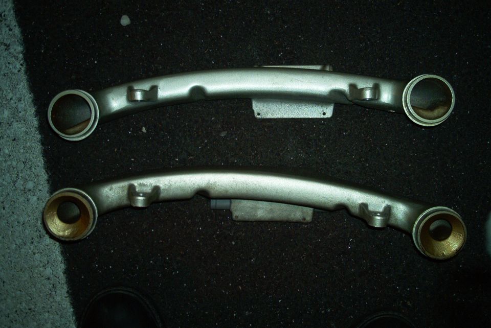 Pair of silver control arms with brass bushings