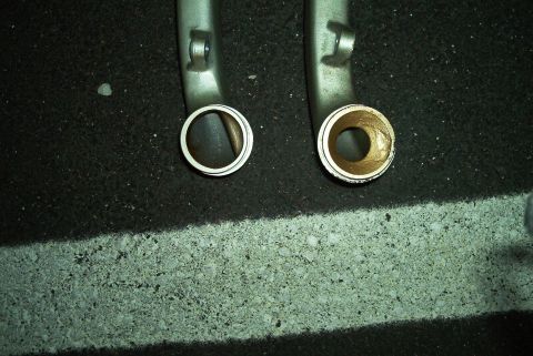 1992 Ford Taurus - Close-up of two intake manifold pipes, one showing a silver ring and the other a brass bushing.
