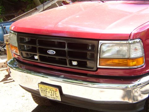 1995 Ford Bronco - Front view of a red 1995 Ford Bronco, its black grille and New Jersey license plate.