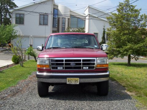 1995 Ford Bronco - Front view of a red 1995 Ford Bronco parked in a driveway.