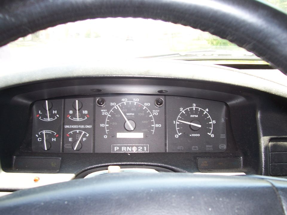 1995 Ford Bronco dashboard with speedometer, tachometer, fuel, and temperature gauges visible