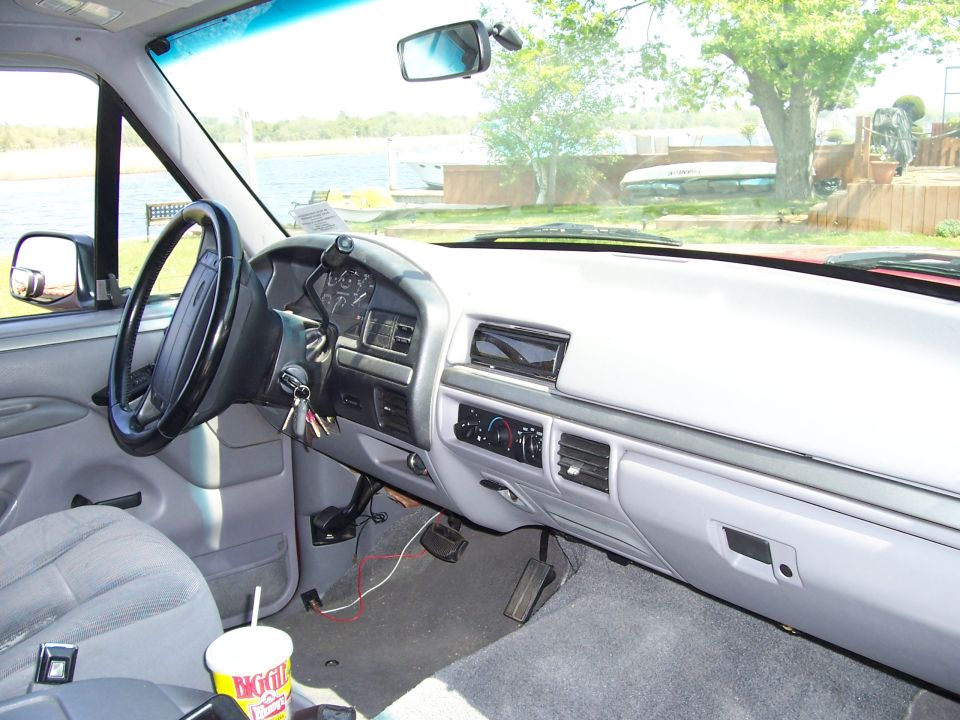 1995 Ford Bronco interior with gray seats and dashboard