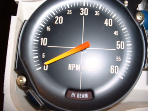 1978 Ford Mustang II - A close-up of a vehicle's tachometer gauge, showing engine RPM and a high beam indicator light.